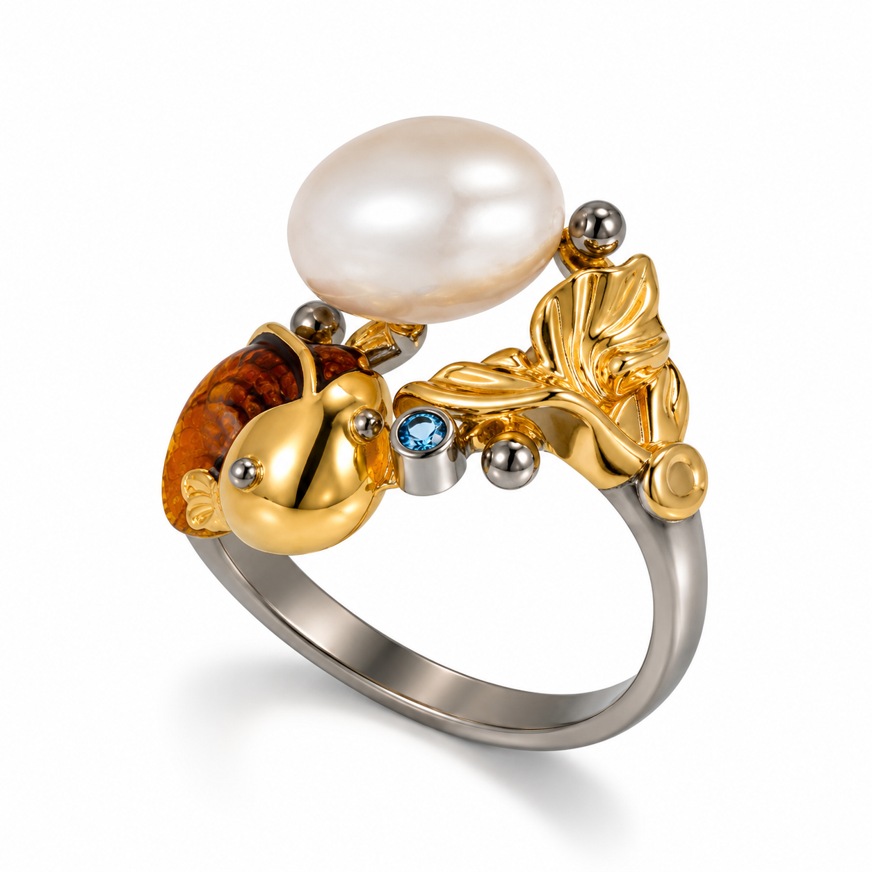 A gold and silver ring featuring a large white pearl, a gold leaf motif, and a gold fish-shaped setting with amber detailing and small blue gemstones, shown on a white background.